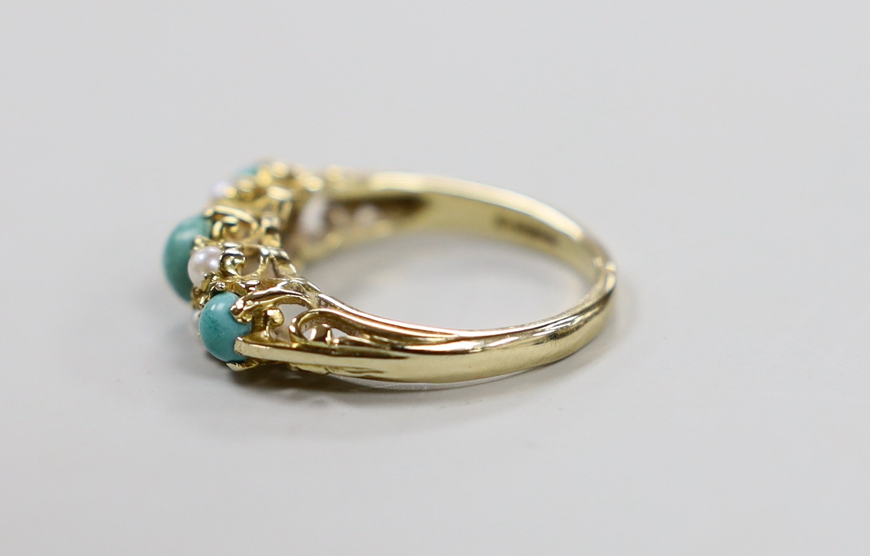 A 1960's 9ct gold, split pearl and turquoise ring set half hoop ring, size O, gross weight 3.4 grams.
